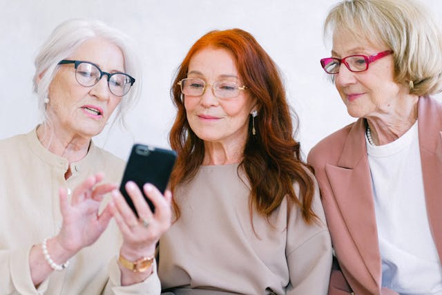 aged woman social looking smartphone