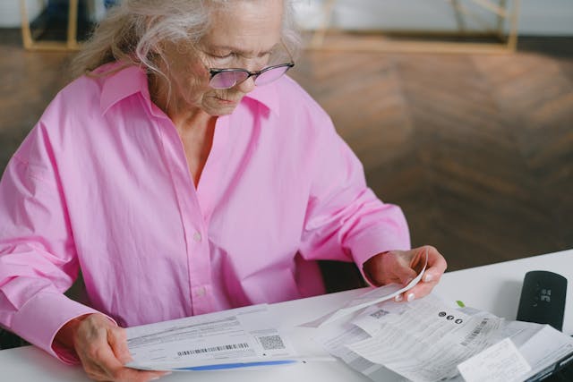 senior woman checking bills