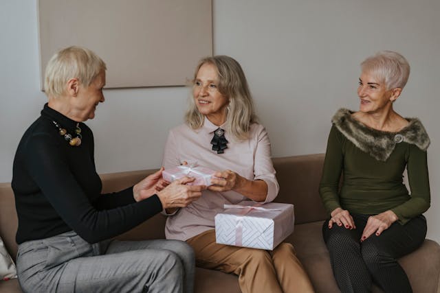 Three Women Sitting with Presents