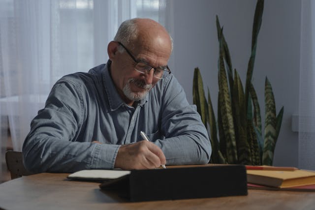 retired man writing reading