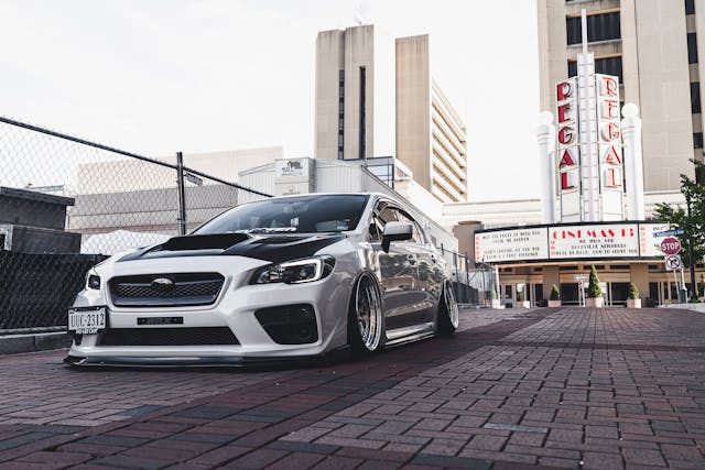 Tuned sports car parked near regal cinemas