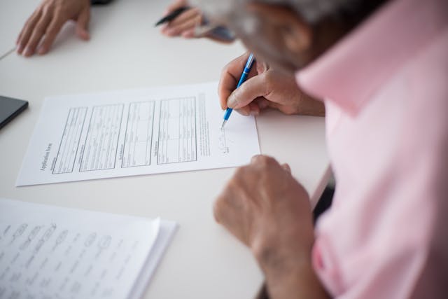 elderly man signing document poa
