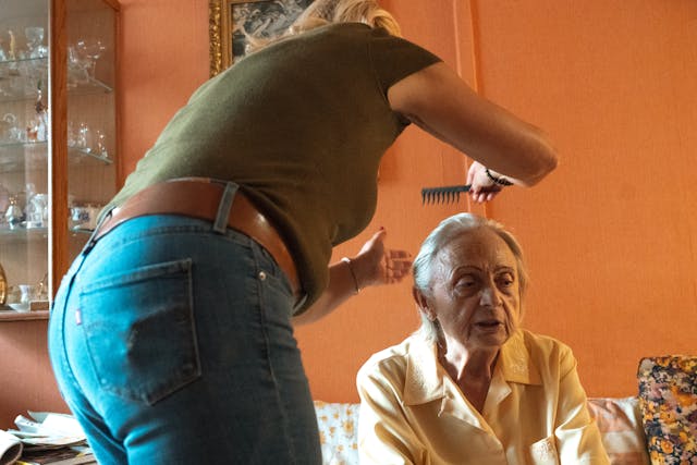 Caregiver Assisting Senior Woman