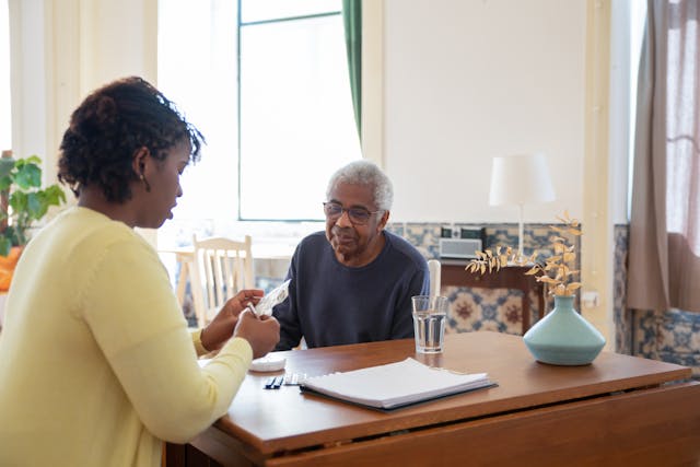 A Woman preparing Medicine for an Elderly Man