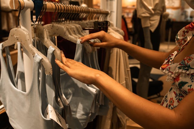 Woman Choosing Tops on Hangers