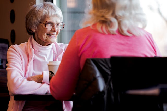Old Woman Sitting While Talking With Another Woman
