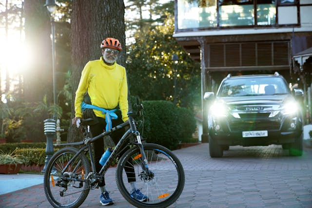 Elderly Cyclist in Bright Gear with Mountain Bike