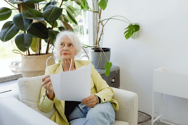 Elderly Woman Holding Documents