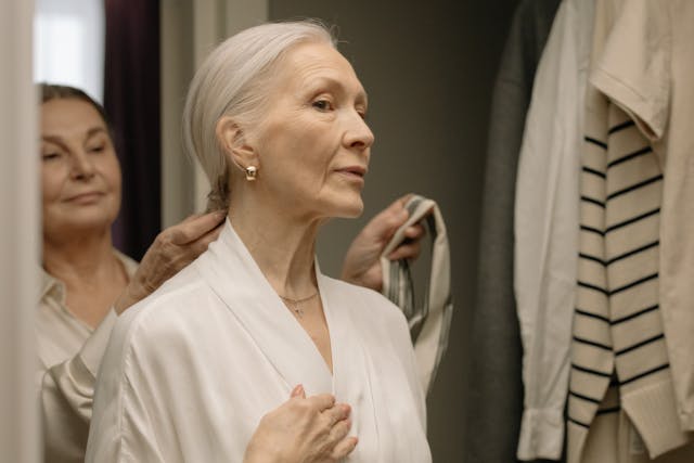 Sophisticated senior woman adjusting her hair