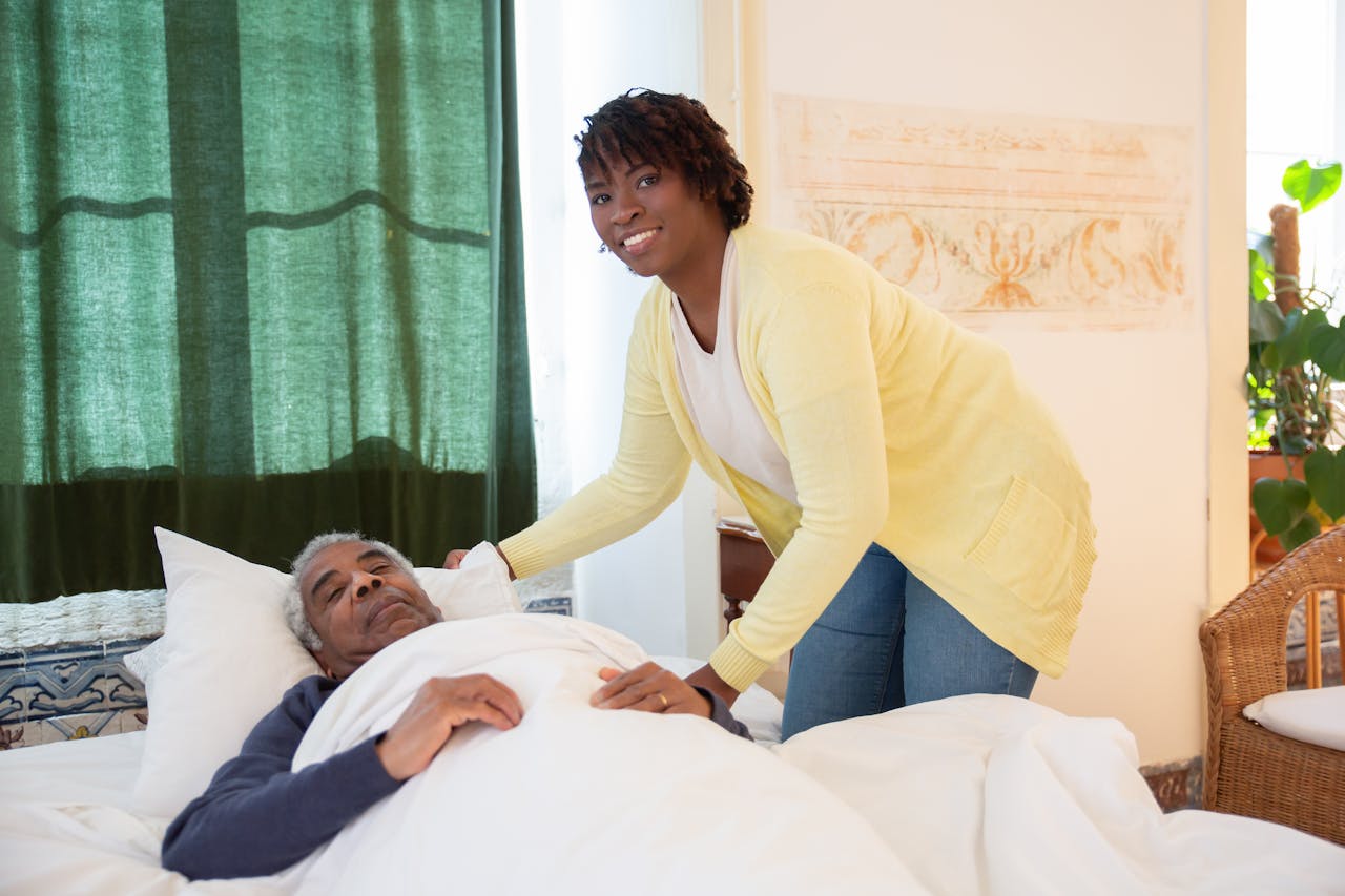 A caregiver tending to an elderly man